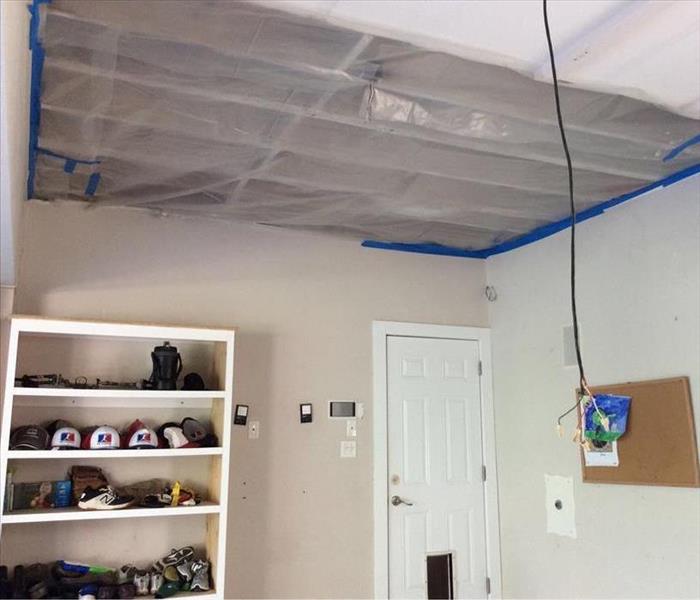 Ceiling with plastic barrier held by tape