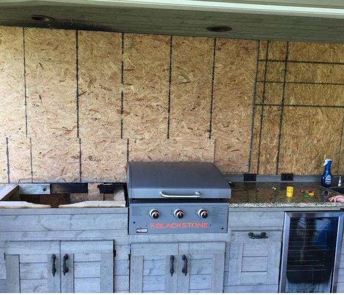Cabinet and grill with fiberboard wall