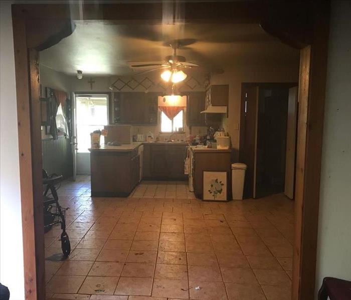 Kitchen with dirty floors and grimy surfaces