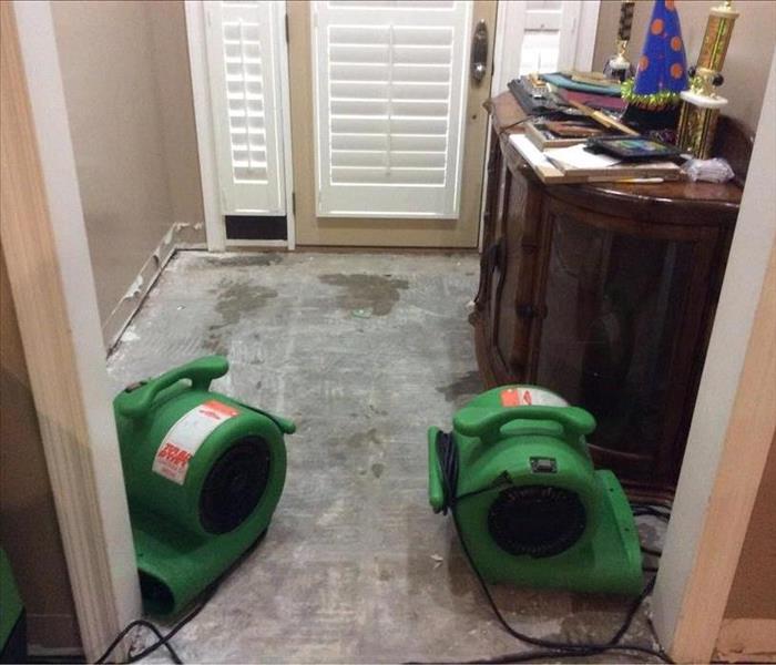 SERVPRO equipment in the room with an exposed subfloor