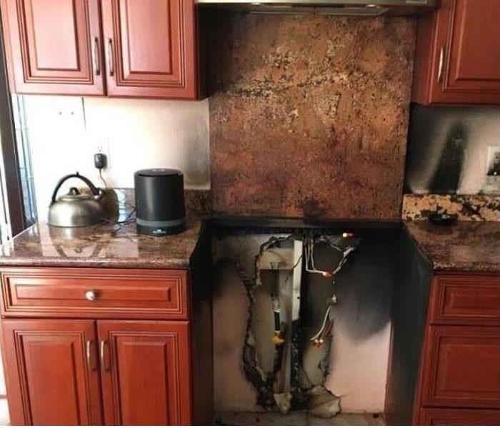 burned kitchen, removed stove showing electric