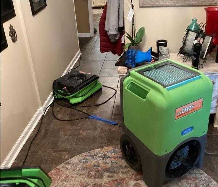 water damaged room; SERVPRO drying equipment seen being used