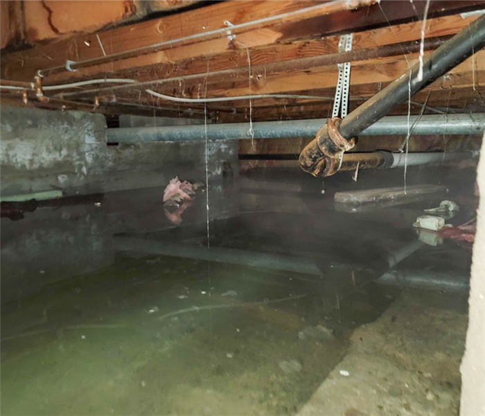 a flooded crawlspace with water halfway up the walls